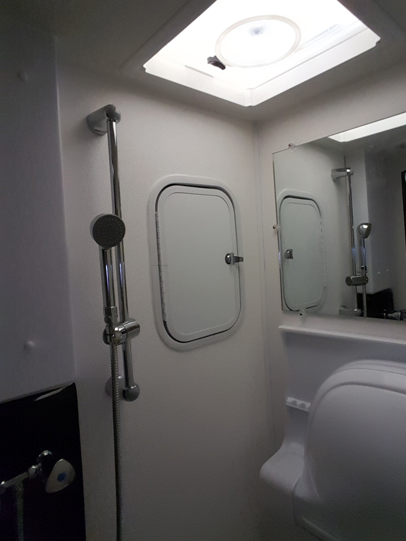 Built-In Storage Compartment in Wet Bath in Cirrus 920 Truck Camper